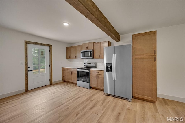 10293 Strange Rd, Potosi, MO 63664 - kitchen featuring appliances with stainless steel finishes, light wood-type flooring, decorative backsplash, beamed ceiling, and light countertops