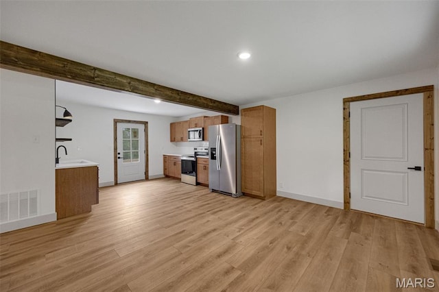 10293 Strange Rd, Potosi, MO 63664 - kitchen featuring stainless steel appliances, brown cabinets, light wood-style flooring, light countertops, and beamed ceiling