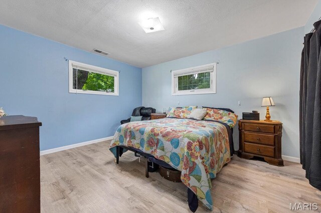 48 Marie Dr, Saint Charles, MO 63301 - bedroom featuring wood finished floors and a textured ceiling