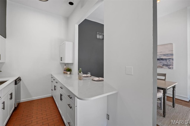 1302 S 10th, Saint Louis, MO 63104 - kitchen featuring white cabinets, dishwasher, light countertops, and brick patterned floors