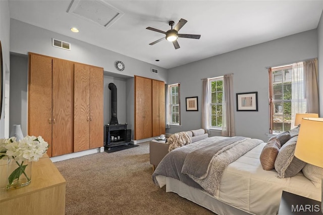 1302 S 10th, Saint Louis, MO 63104 - bedroom featuring a wood stove, carpet floors, ceiling fan, multiple closets, and attic access
