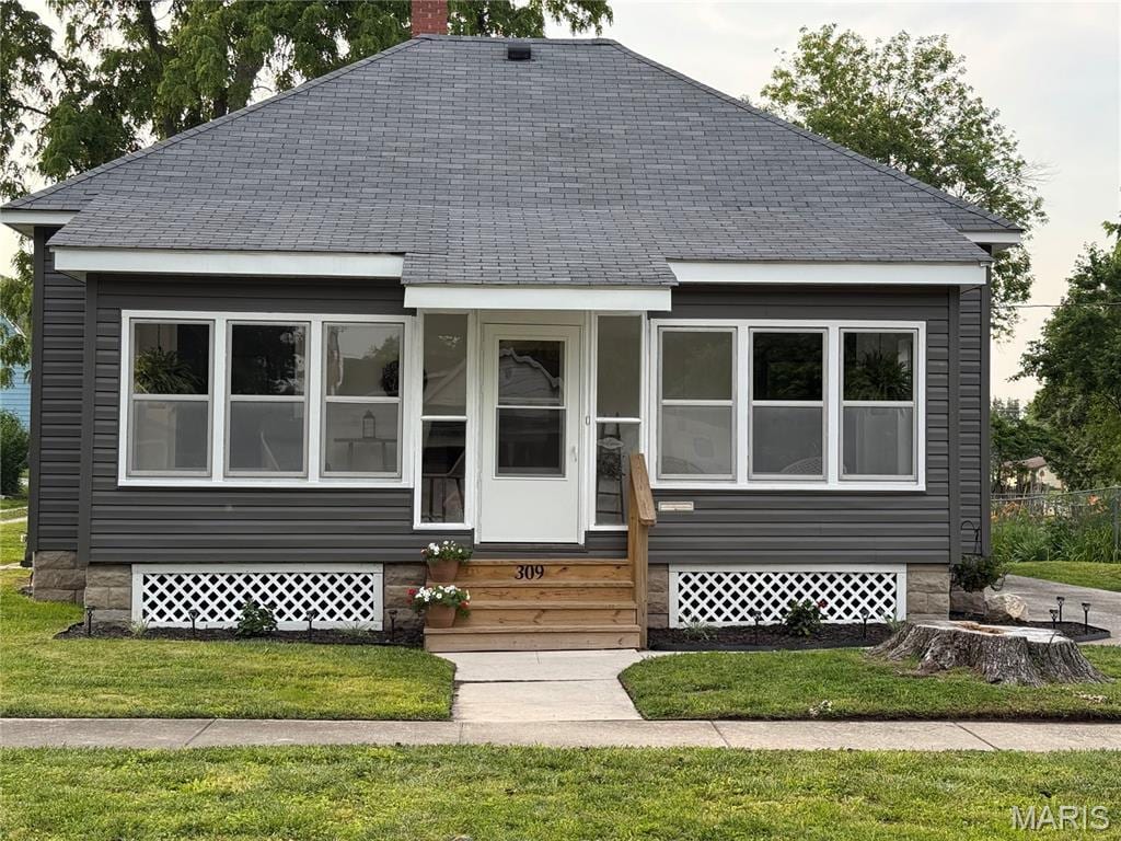 309 E Pearl St, Jerseyville, IL 62052 - view of front of home featuring roof with shingles, a chimney, a front lawn, and entry steps