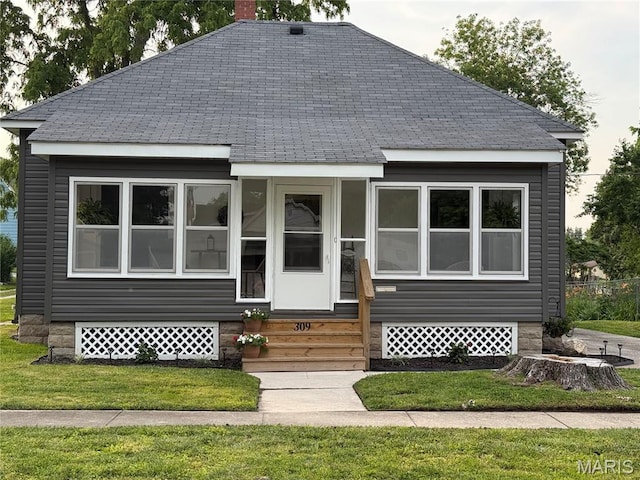 309 E Pearl St, Jerseyville, IL 62052 - view of front of home featuring roof with shingles, a chimney, a front lawn, and entry steps