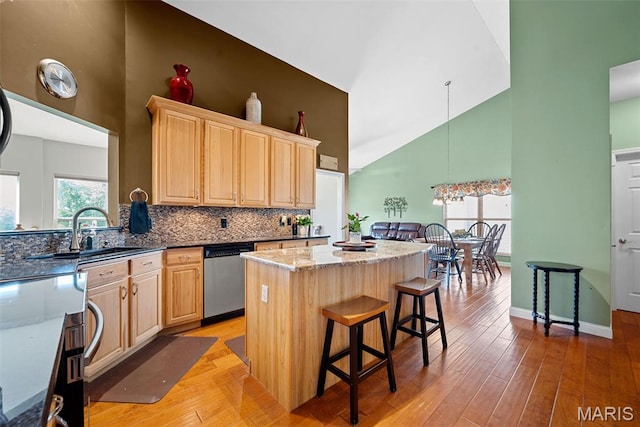 6 Wolverton Ct, Saint Charles, MO 63301 - kitchen with dishwasher, high vaulted ceiling, light brown cabinetry, a center island, and backsplash