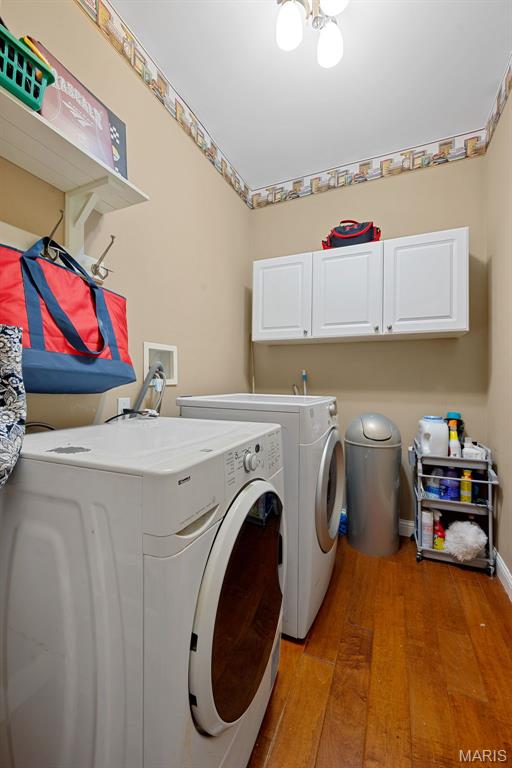 6 Wolverton Ct, Saint Charles, MO 63301 - laundry area featuring cabinet space, washing machine and clothes dryer, and light wood-style floors