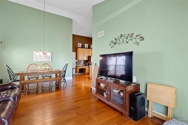 6 Wolverton Ct, Saint Charles, MO 63301 - living area featuring a high ceiling, a chandelier, and light wood-style flooring