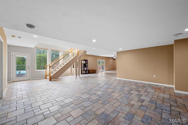 6 Wolverton Ct, Saint Charles, MO 63301 - unfurnished living room with plenty of natural light, stairs, recessed lighting, and stone finish flooring