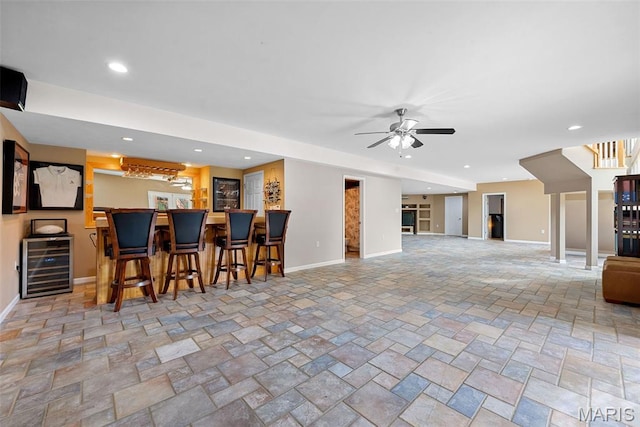 6 Wolverton Ct, Saint Charles, MO 63301 - kitchen with beverage cooler, a ceiling fan, stone finish floors, recessed lighting, and a breakfast bar area