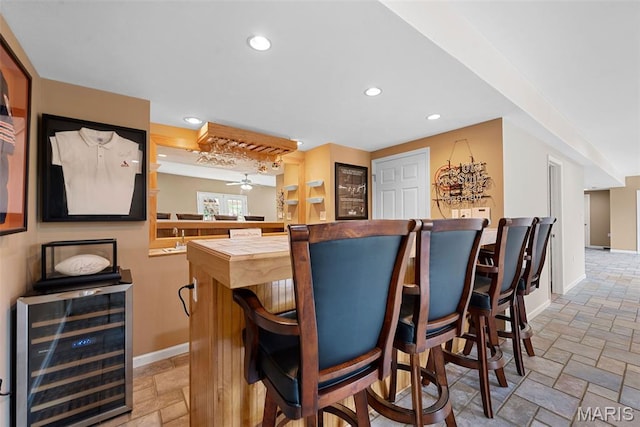6 Wolverton Ct, Saint Charles, MO 63301 - indoor dry bar featuring beverage cooler, stone tile floors, recessed lighting, and ceiling fan