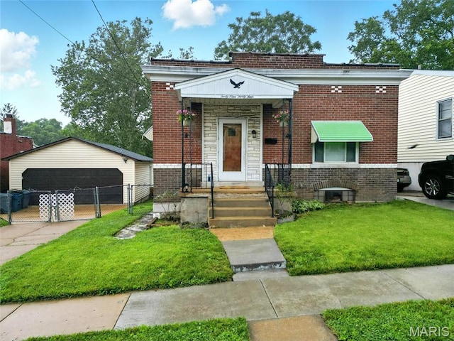 4934 Tiemann Ave, Saint Louis, MO 63123 - view of front of home with brick siding, a garage, and an outbuilding