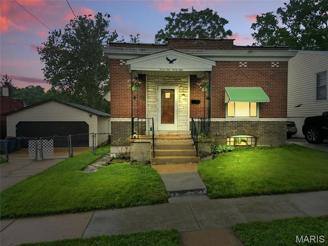 4934 Tiemann Ave, Saint Louis, MO 63123 - view of front of home with brick siding, a garage, and an outdoor structure
