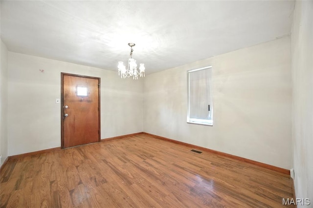 4934 Tiemann Ave, Saint Louis, MO 63123 - empty room with a chandelier and wood finished floors