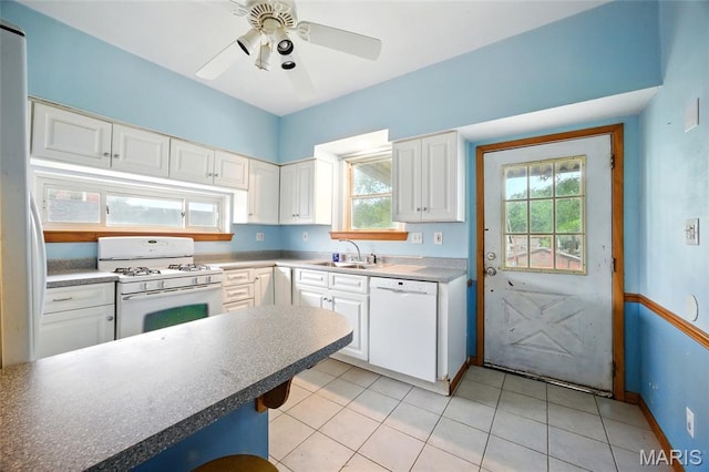 4934 Tiemann Ave, Saint Louis, MO 63123 - kitchen with white appliances, white cabinetry, plenty of natural light, and light tile patterned floors
