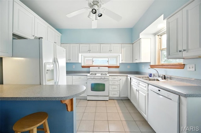 4934 Tiemann Ave, Saint Louis, MO 63123 - kitchen with white appliances, light tile patterned floors, white cabinetry, a kitchen breakfast bar, and a ceiling fan