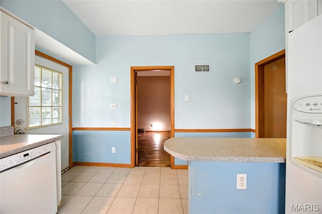 4934 Tiemann Ave, Saint Louis, MO 63123 - kitchen with white appliances, white cabinets, light countertops, and light tile patterned floors