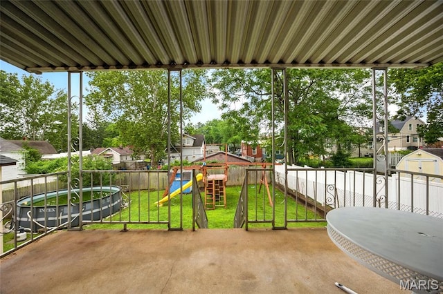 4934 Tiemann Ave, Saint Louis, MO 63123 - fenced backyard featuring a playground, a patio area, and a residential view