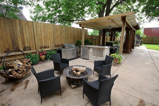 302 N Main St, Saint Elmo, IL 62458 - fenced backyard featuring a fire pit, exterior kitchen, a pergola, and a patio area