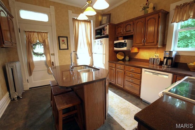302 N Main St, Saint Elmo, IL 62458 - kitchen with radiator heating unit, white appliances, plenty of natural light, crown molding, and an island with sink