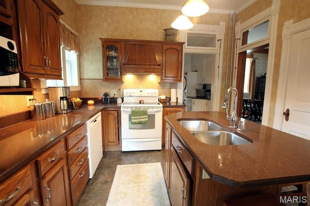 302 N Main St, Saint Elmo, IL 62458 - kitchen with white appliances, crown molding, custom exhaust hood, glass insert cabinets, and a center island with sink