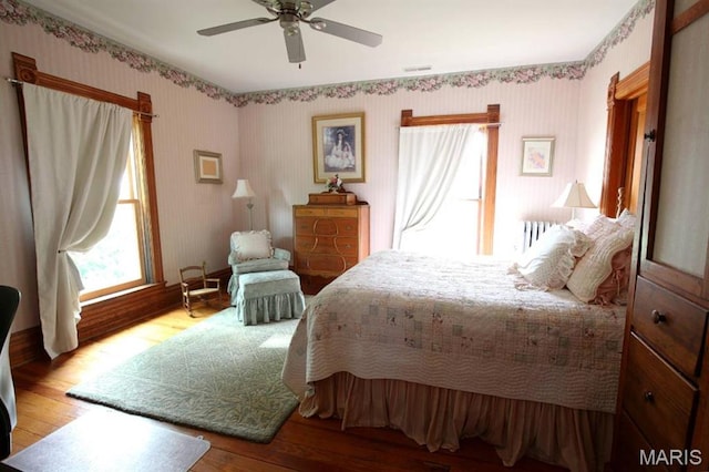 302 N Main St, Saint Elmo, IL 62458 - bedroom featuring wood finished floors, wallpapered walls, and ceiling fan
