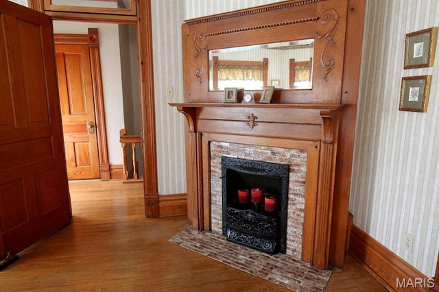 302 N Main St, Saint Elmo, IL 62458 - detailed view of wallpapered walls, wood finished floors, and a fireplace with flush hearth