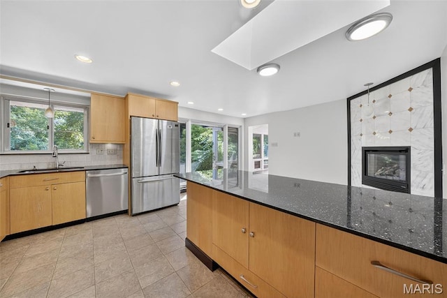 3 Cardigan Ln, Saint Louis, MO 63135 - kitchen with appliances with stainless steel finishes, plenty of natural light, recessed lighting, and dark stone countertops