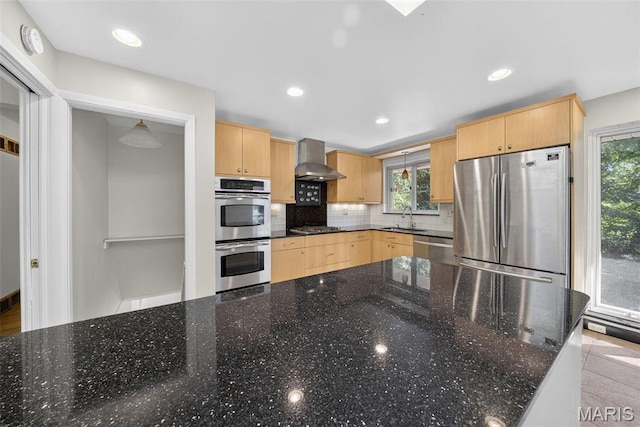 3 Cardigan Ln, Saint Louis, MO 63135 - kitchen featuring stainless steel appliances, light brown cabinets, wall chimney exhaust hood, plenty of natural light, and recessed lighting