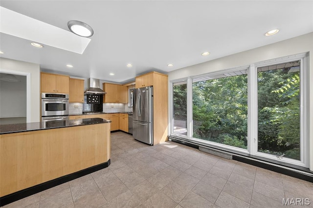 3 Cardigan Ln, Saint Louis, MO 63135 - kitchen with stainless steel appliances, wall chimney exhaust hood, light brown cabinets, tasteful backsplash, and recessed lighting