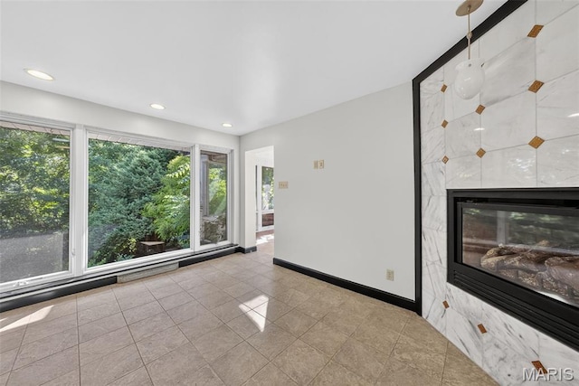 3 Cardigan Ln, Saint Louis, MO 63135 - tiled spare room with recessed lighting and a high end fireplace