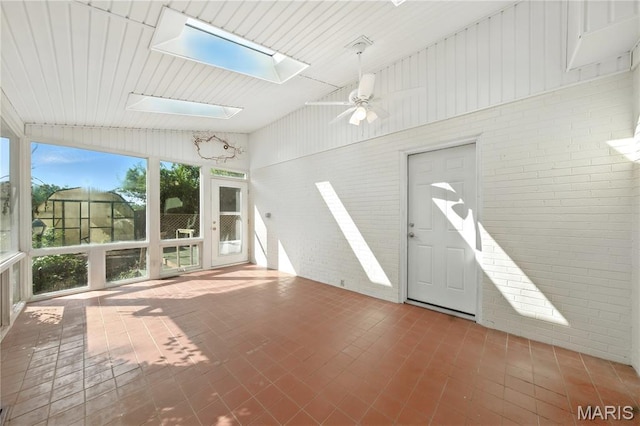 3 Cardigan Ln, Saint Louis, MO 63135 - unfurnished sunroom featuring a skylight, brick wall, and vaulted ceiling
