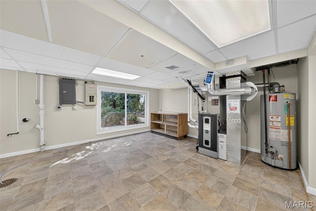 3 Cardigan Ln, Saint Louis, MO 63135 - below grade area with gas water heater, electric panel, heating unit, stone finish floors, and a paneled ceiling