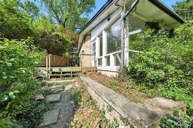 3 Cardigan Ln, Saint Louis, MO 63135 - view of side of property with a sunroom and a deck