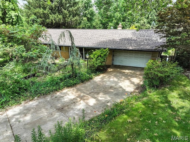 3 Cardigan Ln, Saint Louis, MO 63135 - ranch-style house featuring concrete driveway, an attached garage, a shingled roof, and a chimney