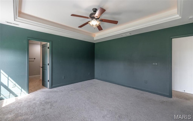 111 Brush Creek Pkwy, Saint Robert, MO 65584 - carpeted spare room with a raised ceiling, a ceiling fan, and crown molding