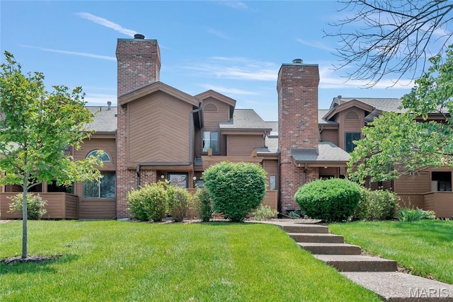 225 Hemingway Ln Unit F, Weldon Spring, MO 63304 - rear view of property featuring a yard, a chimney, and brick siding
