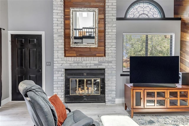 225 Hemingway Ln Unit F, Weldon Spring, MO 63304 - living room featuring a fireplace and wood finished floors