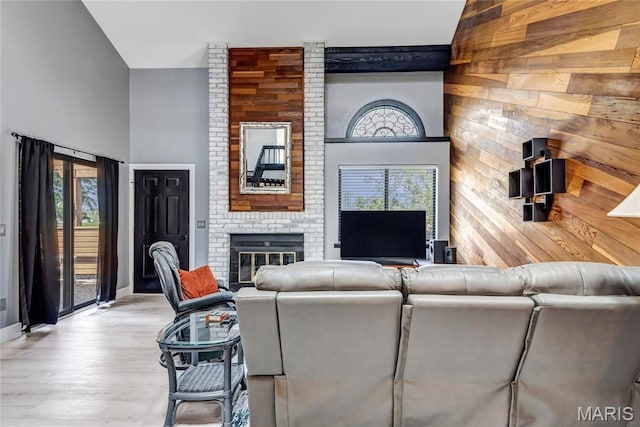 225 Hemingway Ln Unit F, Weldon Spring, MO 63304 - living area with a brick fireplace, wood finished floors, and a high ceiling
