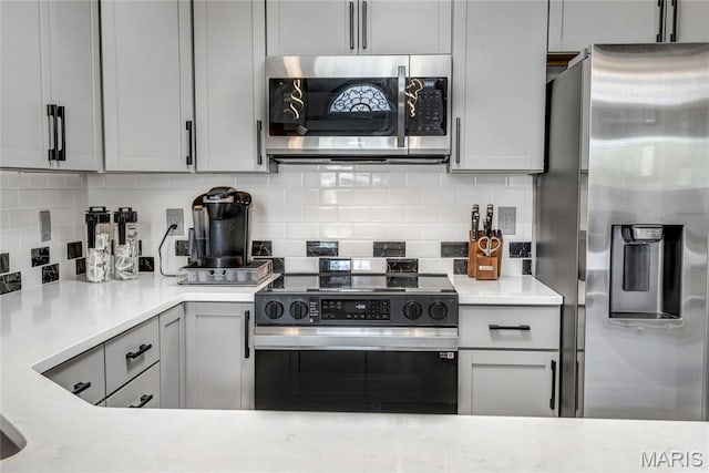 225 Hemingway Ln Unit F, Weldon Spring, MO 63304 - kitchen with appliances with stainless steel finishes, backsplash, and light countertops