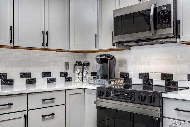 225 Hemingway Ln Unit F, Weldon Spring, MO 63304 - kitchen featuring stainless steel appliances, backsplash, and light countertops