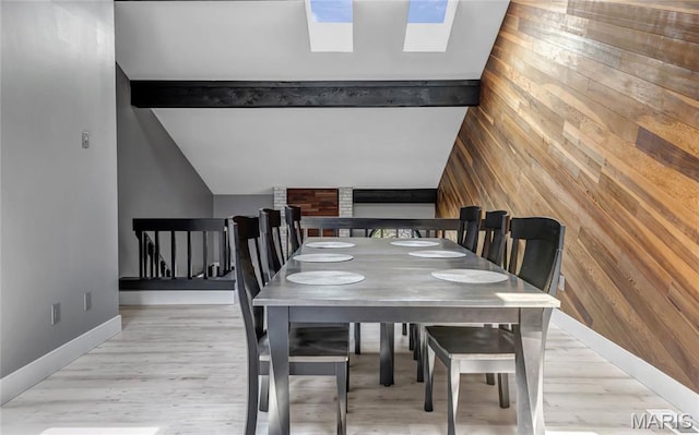 225 Hemingway Ln Unit F, Weldon Spring, MO 63304 - dining space with wooden walls, a skylight, and wood finished floors