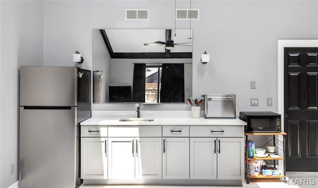 225 Hemingway Ln Unit F, Weldon Spring, MO 63304 - kitchen featuring freestanding refrigerator, black microwave, light countertops, and ceiling fan