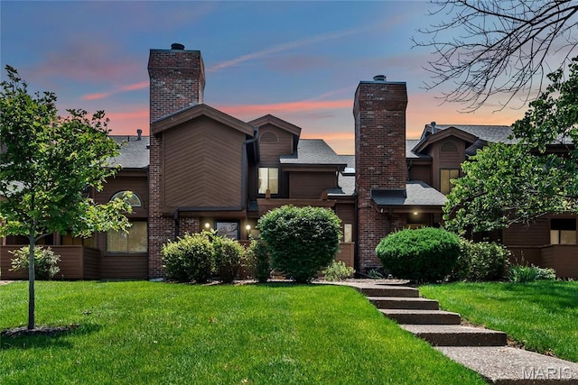 225 Hemingway Ln Unit F, Weldon Spring, MO 63304 - view of front facade with a chimney, a front lawn, and brick siding