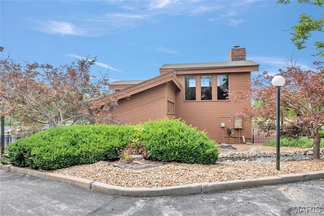 225 Hemingway Ln Unit F, Weldon Spring, MO 63304 - view of home's exterior with a chimney