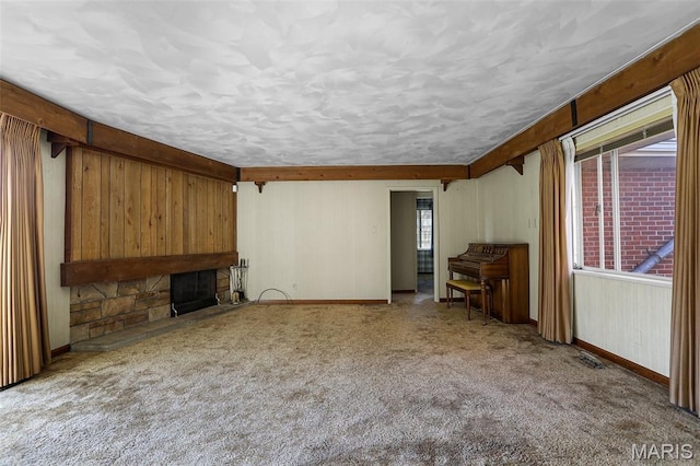 4831 S State Route 159, Glen Carbon, IL 62034 - unfurnished living room featuring plenty of natural light, a textured ceiling, carpet floors, and a stone fireplace