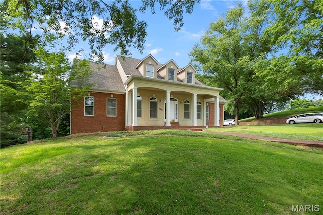 2615 Saddle Ridge Ln, Cape Girardeau, MO 63701 - cape cod home with a porch, a front lawn, and brick siding
