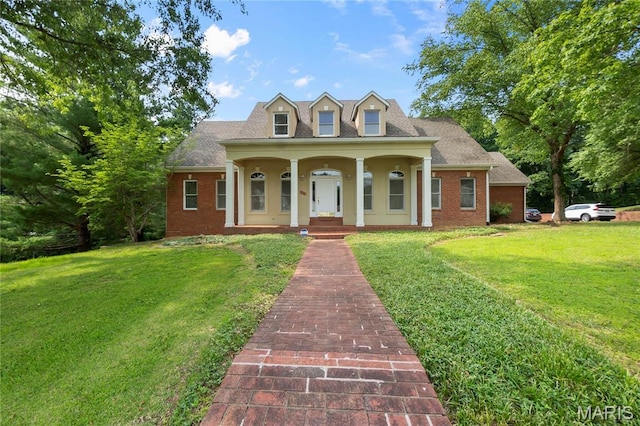 2615 Saddle Ridge Ln, Cape Girardeau, MO 63701 - new england style home featuring covered porch, a front yard, brick siding, and roof with shingles