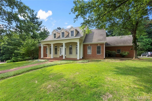 2615 Saddle Ridge Ln, Cape Girardeau, MO 63701 - new england style home featuring a porch, a front lawn, and brick siding