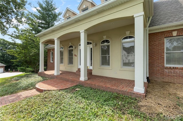 2615 Saddle Ridge Ln, Cape Girardeau, MO 63701 - doorway to property with a porch, a shingled roof, and brick siding