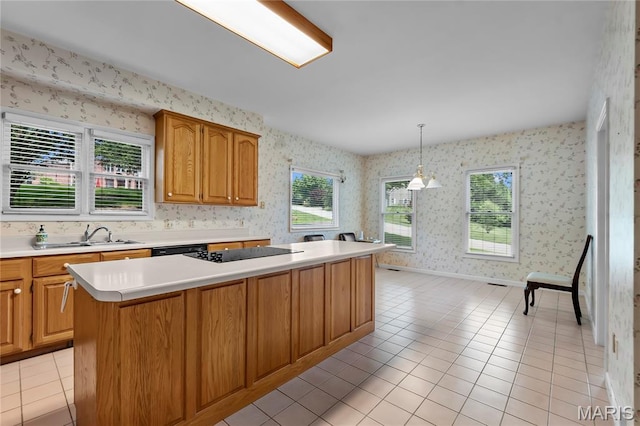 2615 Saddle Ridge Ln, Cape Girardeau, MO 63701 - kitchen featuring light countertops, wallpapered walls, light tile patterned floors, a center island, and black appliances