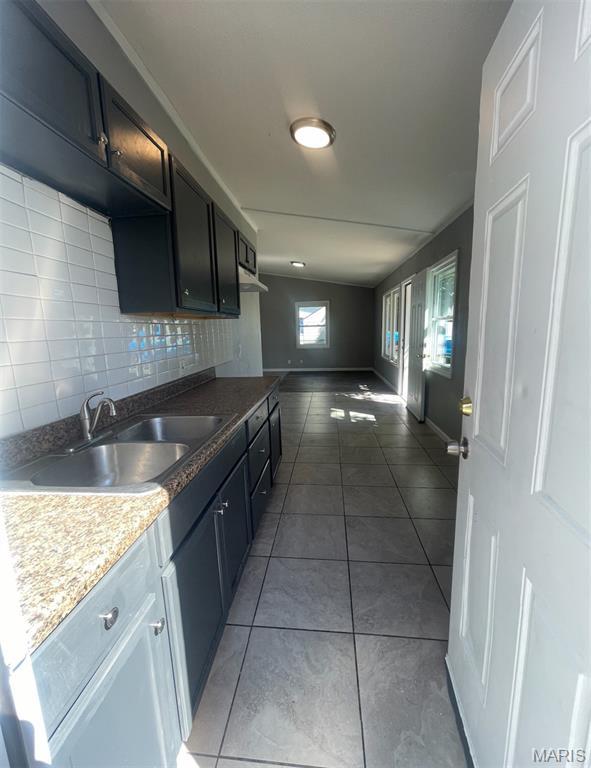1115 Saint Michael Dr, Cahokia, IL 62206 - kitchen featuring backsplash, tile patterned floors, and under cabinet range hood